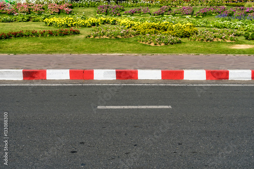 Asphalt road with red and white photo