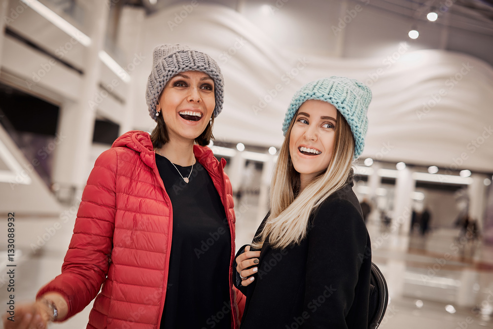 Two girls are happy becouse they have new purchases Two girls are happy becouse they have new purchases