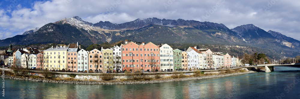 Panorama of  river Inn, colourfull house facades and mountain range at Innsbruck