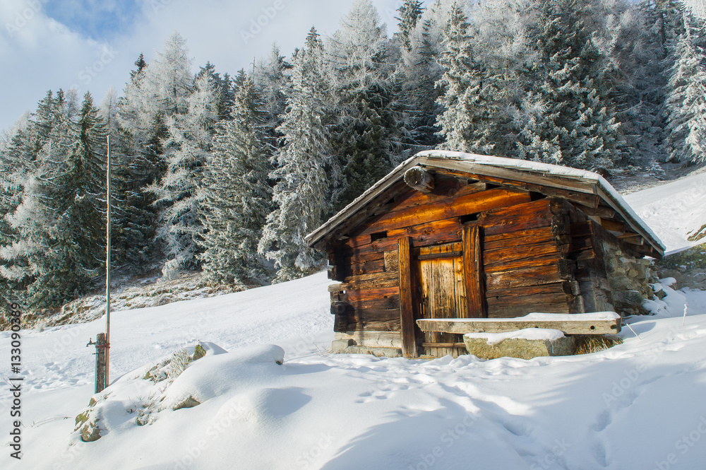 wooden chalet or hut in a winter landscape