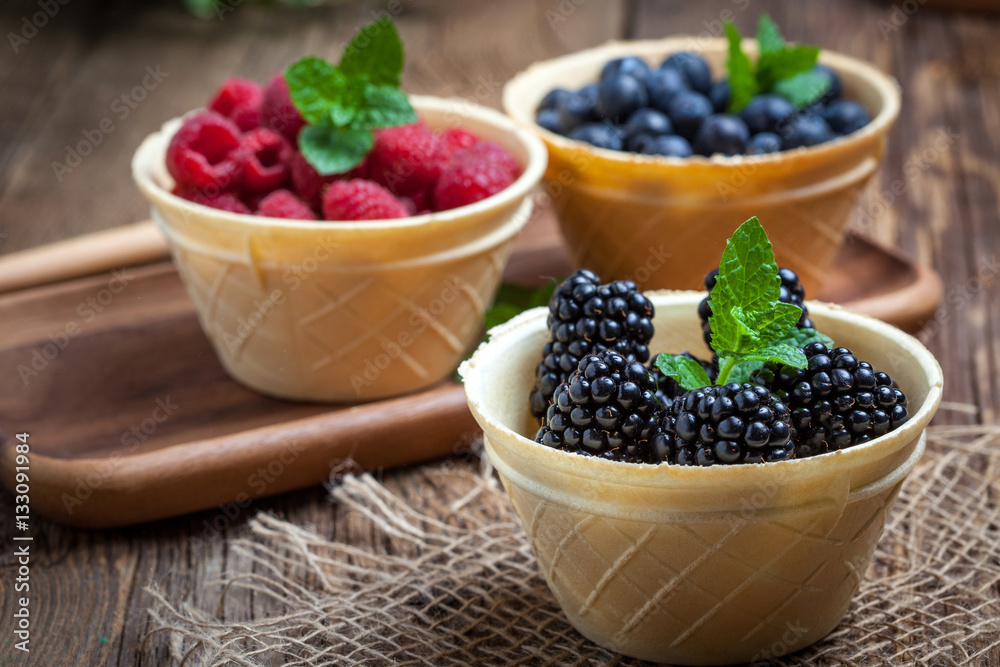 Blackberries, raspberries and blueberries in a waffle bowls. Blackberries, raspberries and blueberries in a waffle bowls.