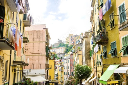 Riomaggiore village, La Spezia, Liguria, northern Italy. Colourful houses on steep hills,castle with clock,laundry on balconies.Part of the Cinque Terre National Park and a UNESCO World Heritage Site. © f8grapher