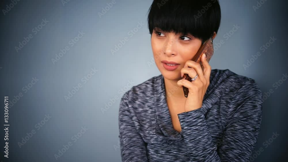 Young woman talking on cell phone, she smiles and laughs. Young woman talking on cell phone, she smiles and laughs.
