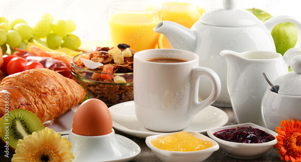 Breakfast served with coffee, juice, egg, and rolls Breakfast served with coffee, juice, egg, and rolls