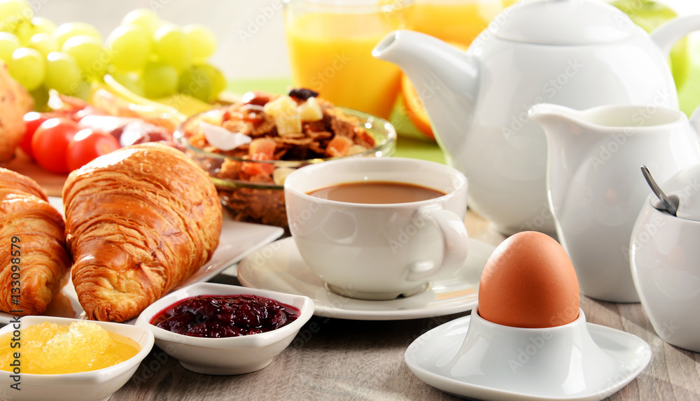 Breakfast served with coffee, juice, egg, and rolls