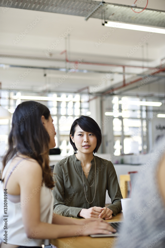 Asian businesswoman with colleagues in an office Asian businesswoman with colleagues in an office
