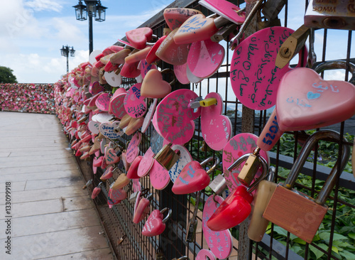 Pink love locks on a fence on Penang Hill