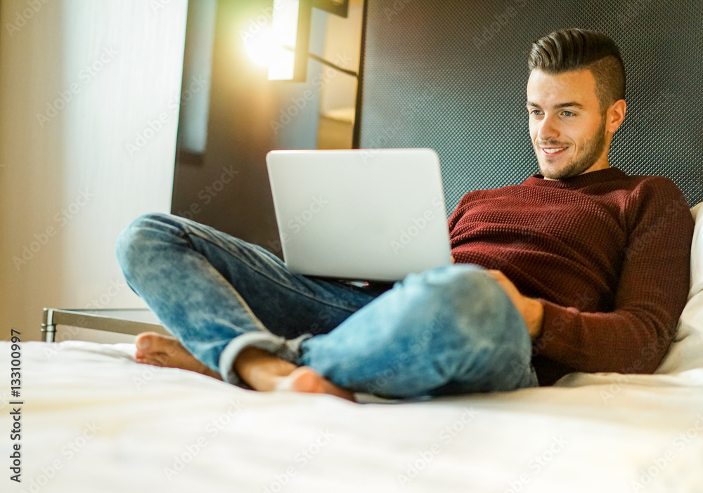Young man using laptop computer for working at home