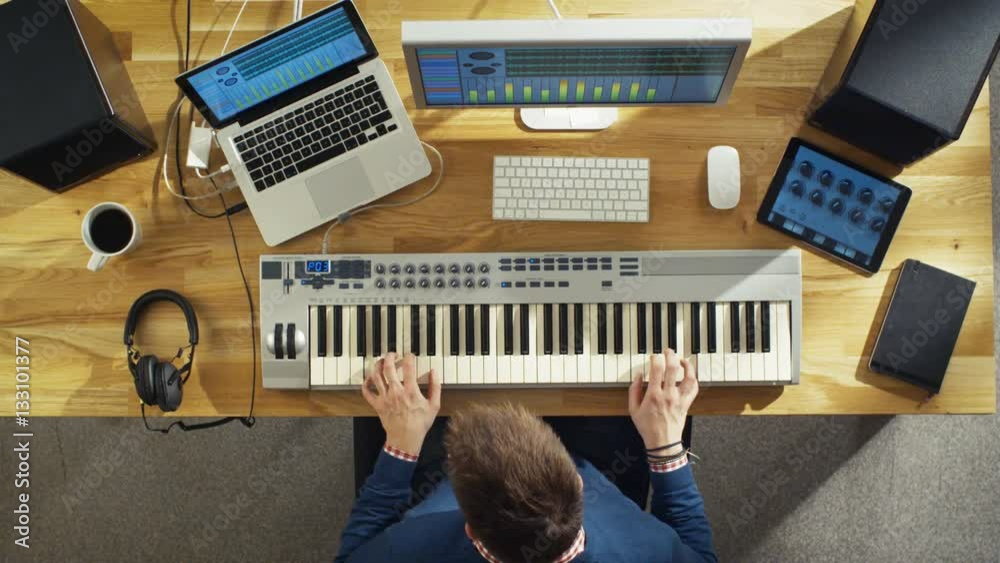 Top View of a Musician Creating Music at His Studio, Playing on a Musical Keyboard. His Studio is Sunny and Pleasant Looking.  Shot on RED Cinema Camera in 4K (UHD).