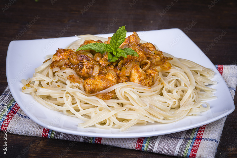 Spaghetti with chicken and vegetable on a plate Spaghetti with chicken and vegetable on a plate