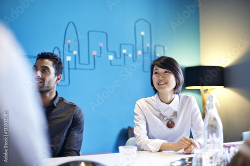 Asian woman with multi ethnicity colleagues in meeting