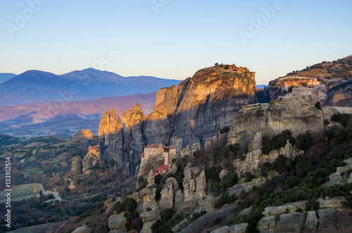 Breathtaking panoramic view of Meteora at sunset, Greece. Geological formations of big rocks with Monasteries on top of them.