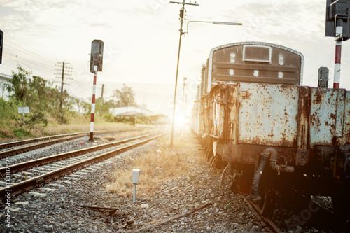 Vintage train On the tracks at an old container work for the sunset. photo