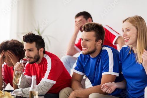 friends or football fans watching soccer at home