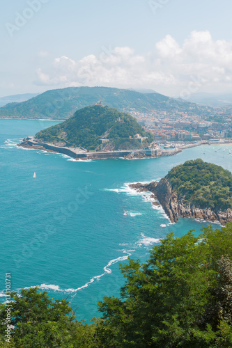 seascape with blue water, boats and the city. San Sebastian Basque Country. Ocean color image © beverli