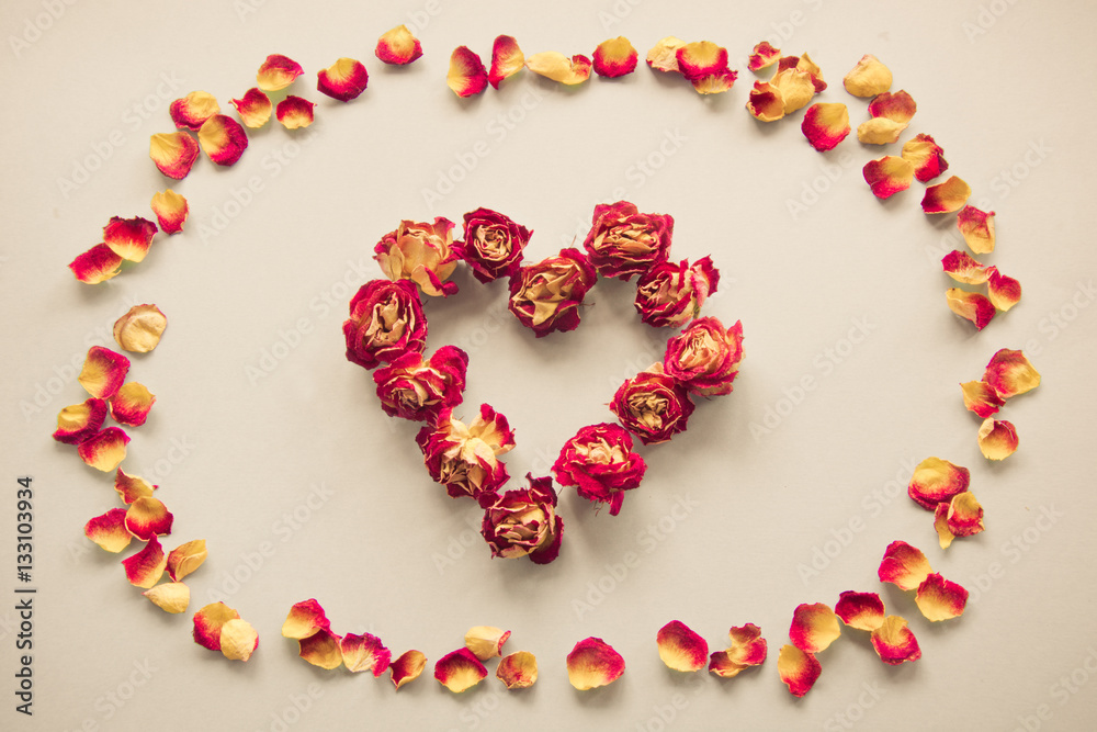 Valentine's card. Heart symbol made of dried roses on a vintage background. Top view, flat lay. Concept, postcard with place for your text. Vintage filter. Valentine's card. Heart symbol made of dried roses on a vintage background. Top view, flat lay. Concept, postcard with place for your text. Vintage filter.