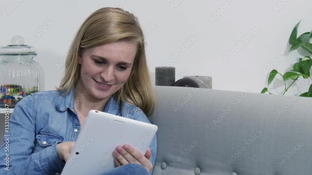 beautiful blond girl doing online shopping with tablet beautiful blond girl doing online shopping with tablet