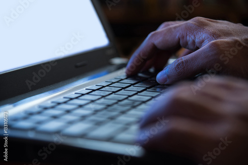 Selective focus on man two hand typing laptop/PC/computer keyboa
