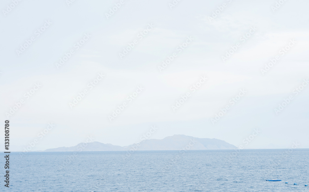 Beach. Calm Sea Ocean And Blue Sky Background.Exotic water landscape with clouds on horizon. Natural tropical water paradise.  Travel tropical island resort. Ocean nature tranquility.  Red sea