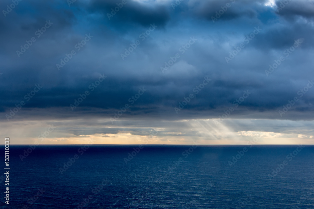 Obraz premium Bright sunlight over ocean, beautiful shine sun beam in sky, abstract blue natural background, peaceful skyscape, open heaven and God, morning sun rays, Mediterranean resort, panoramic sea