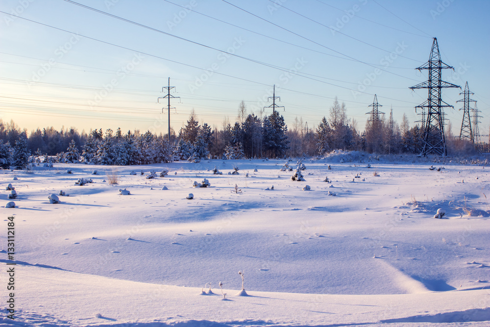 High voltage power lines in the winter. Winter landscape.