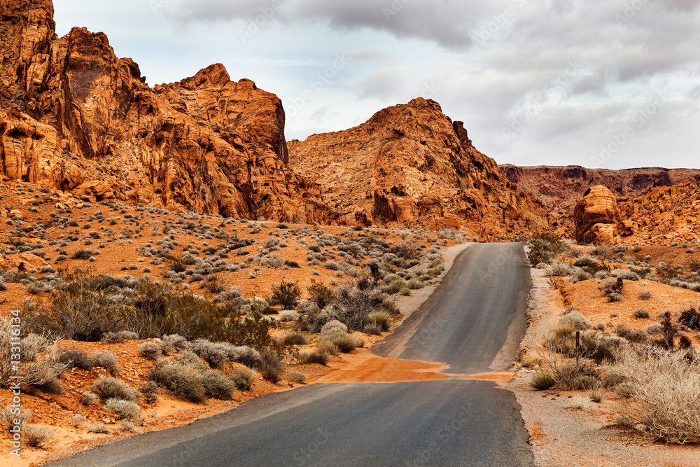 Empty Desert Road with mountains at Valley of Fire State Park, southern Nevada, USA