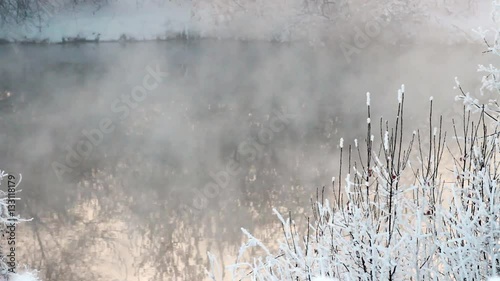 steam rises from river in winter forest