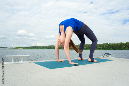 Young woman doing yoga exercise on mat 10