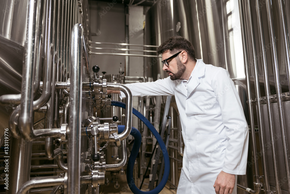 Concentrated man working with brewing mechanism