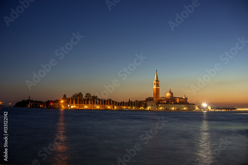 sunset, night view from the sea on illuminated Venice, Italy.