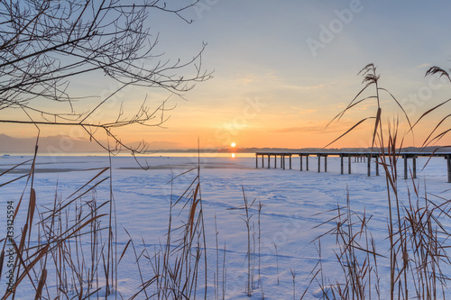Jetty at Lake Chiemsee in Winter at sunset