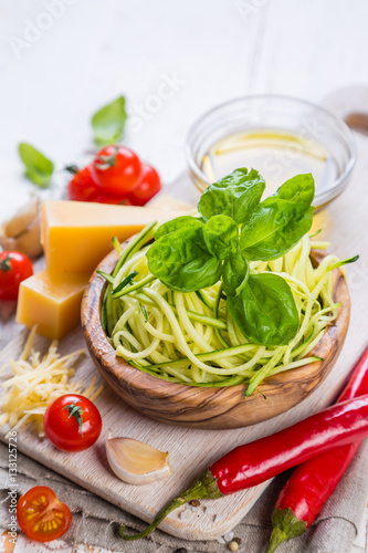Raw zucchini pasta and ingredients