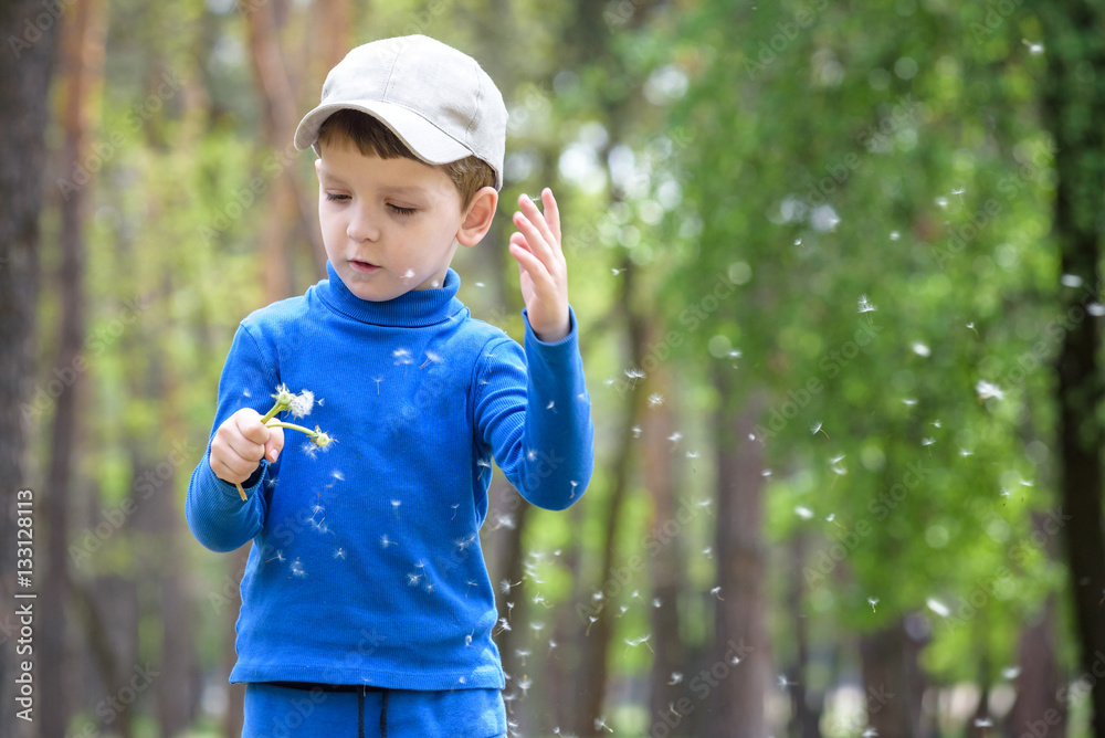 Cute 4 years old boy with dandelion outdoors at sunny summer day. Cute 4 years old boy with dandelion outdoors at sunny summer day.