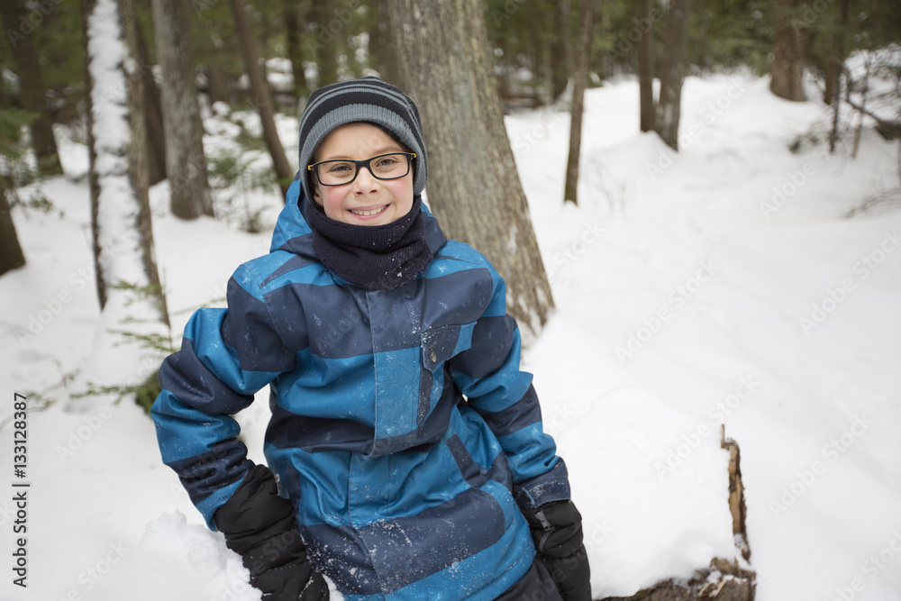 Little boy in winter with hat in snow forest. Little boy in winter with hat in snow forest.
