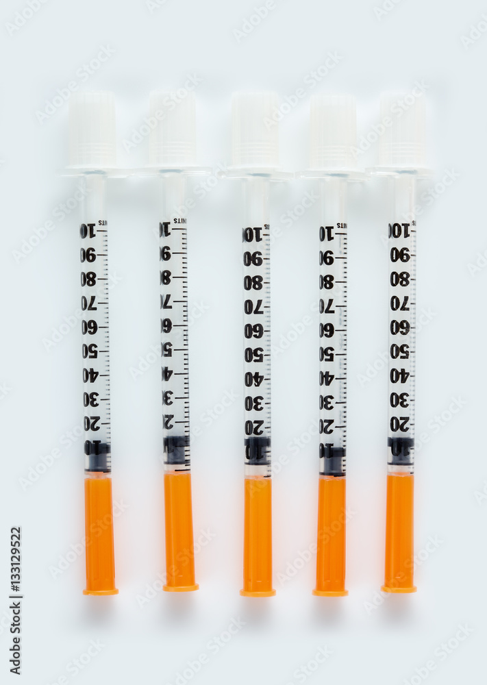 Three insulin syringes isolated on white background. Pile of Medical  syringes. Single insulin syringe with orange cap. Stock Photo | Adobe Stock