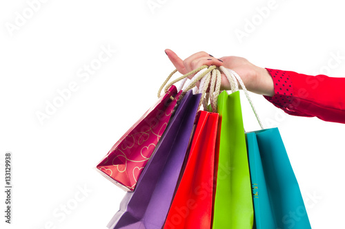 Multicoloured and bright shopping packages hanging on female red