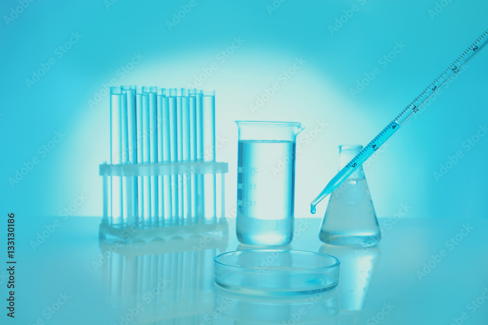 Chemical test-tubes with medicine dropper on color background Chemical test-tubes with medicine dropper on color background