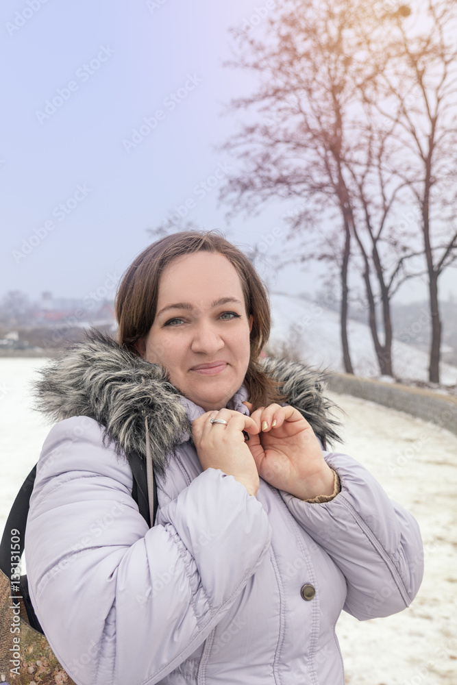 Young woman in the winter park while walking on cold winter day. Portrait close up. Coloring and processing photo with soft focus. Young woman in the winter park while walking on cold winter day. Portrait close up. Coloring and processing photo with soft focus.