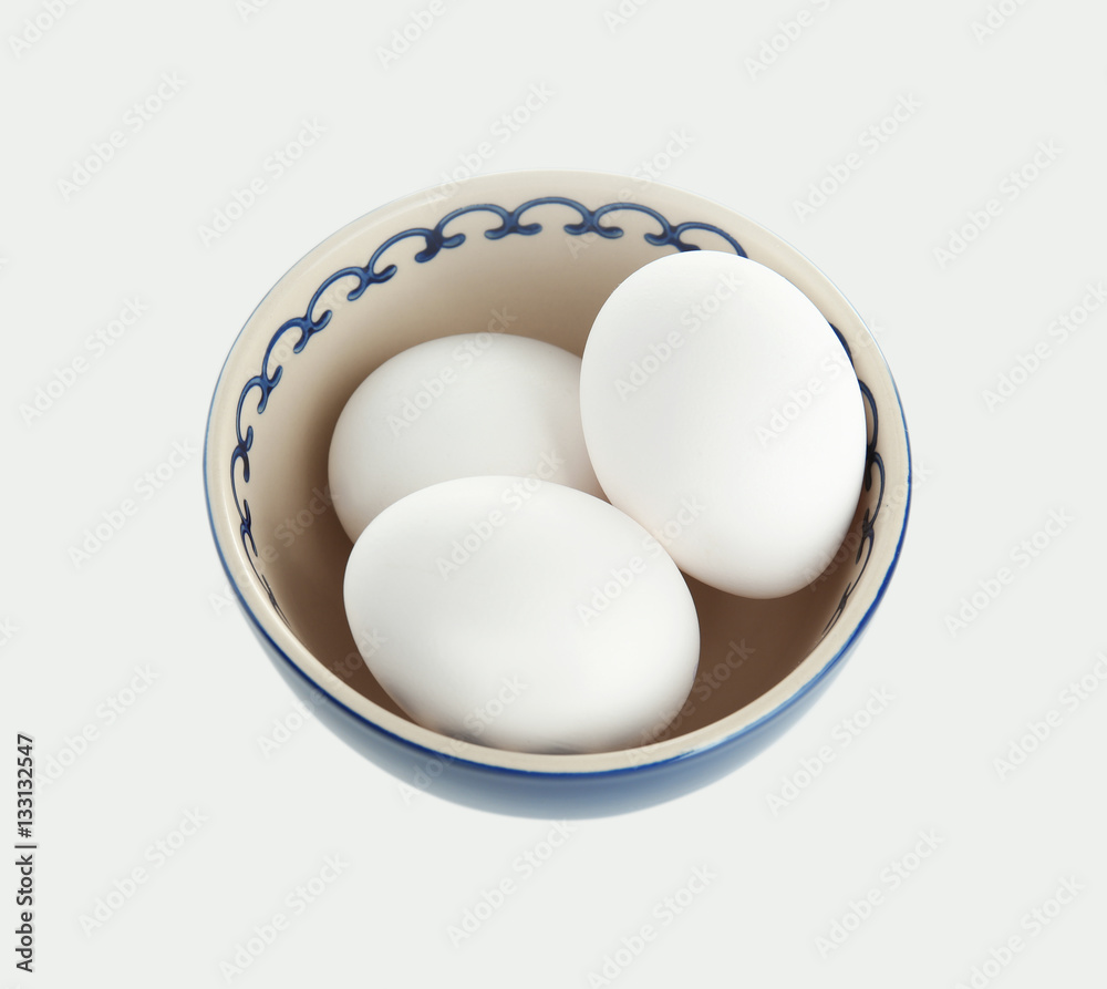 Raw eggs in bowl on white background Raw eggs in bowl on white background