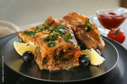 Plate with meat on table