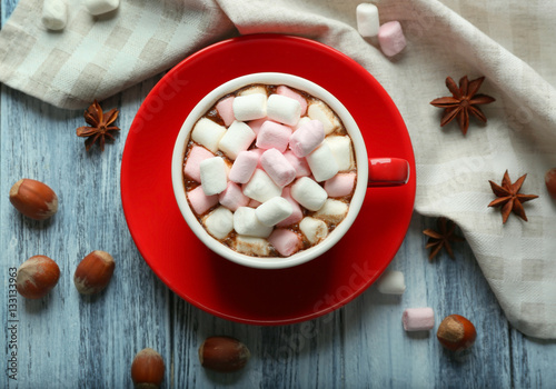 Cup of hot cocoa with marshmallows on table