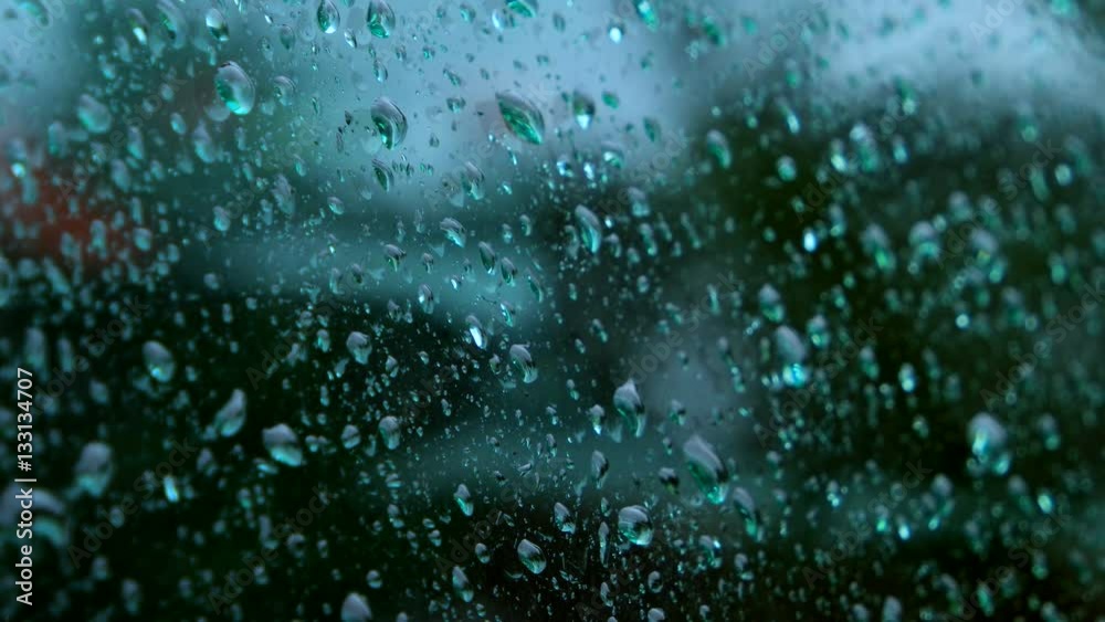 Close up of water drops running on glass Close up of water drops running on glass