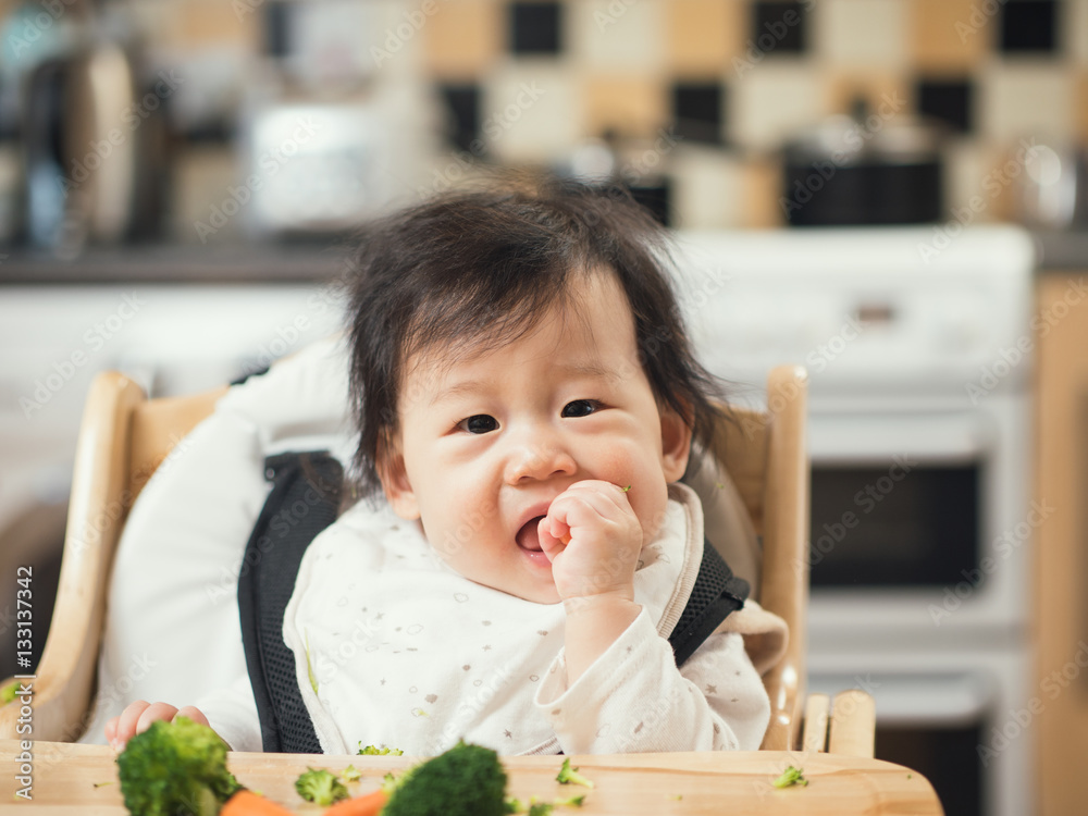baby girl eating broccoli,carrot vegetable first time at home baby girl eating broccoli,carrot vegetable first time at home