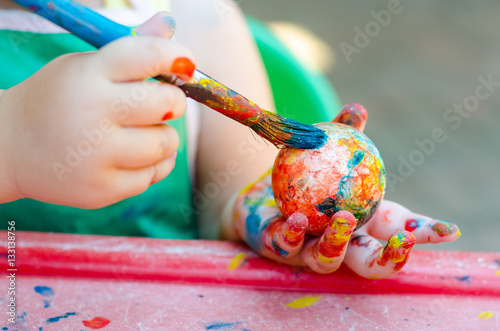 Toddler painting a polystyrene ball