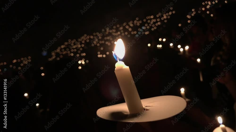 Candle with more candles blurred around.