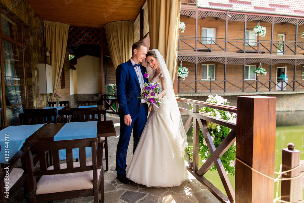 Fototapeta premium Newlywed couple, groom and bride having fun outdoors