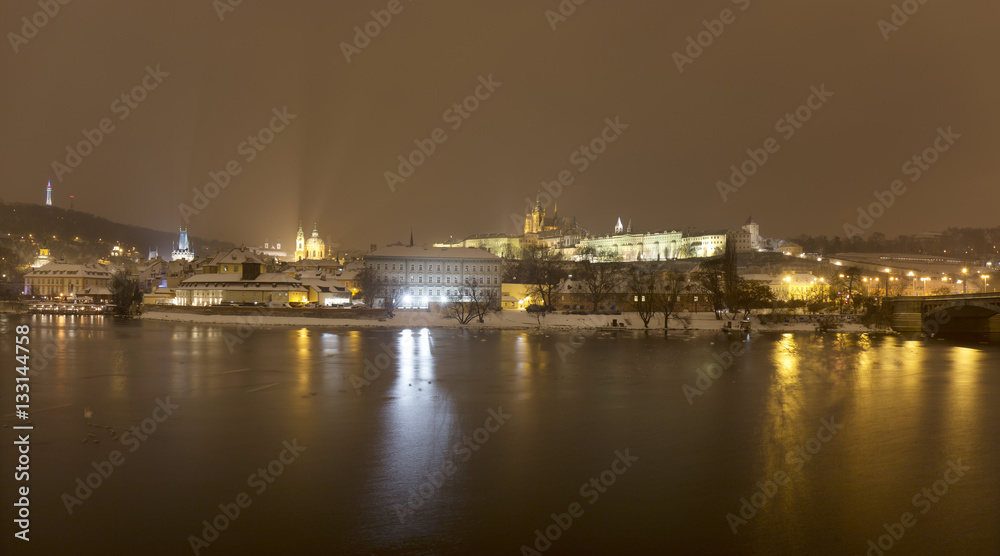Night snowy Prague Lesser Town with gothic Castle above River Vltava, Czech republic Night snowy Prague Lesser Town with gothic Castle above River Vltava, Czech republic