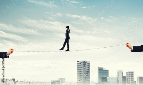 Wallpaper Mural Business concept of risk support and assistance with man balancing on rope Torontodigital.ca