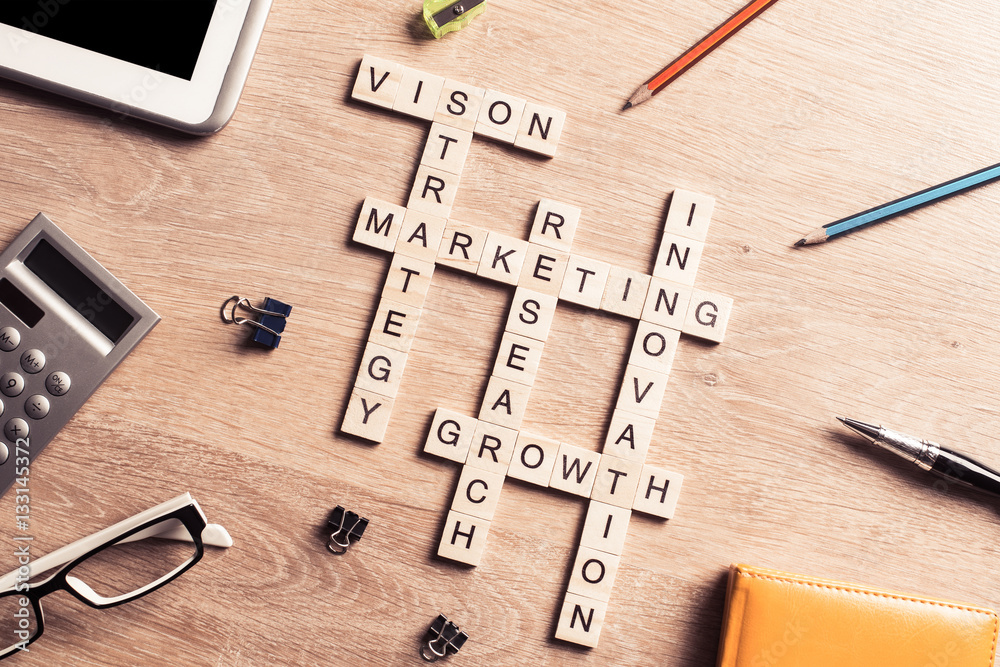 Conceptual business keywords on table with elements of game making crossword Conceptual business keywords on table with elements of game making crossword