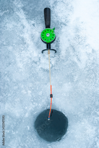 Ice-hole and rod for winter fishing.